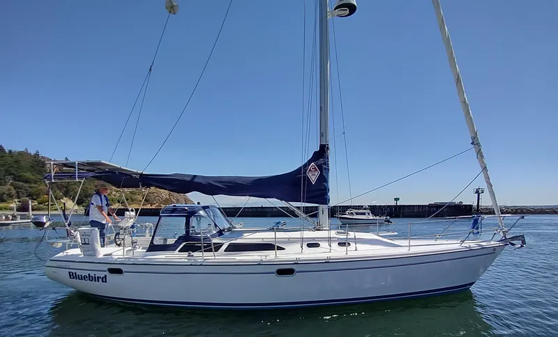Slide: The Image of 2002 Catalina 36 MkII sailboat named Bluebird on calm water. - 2