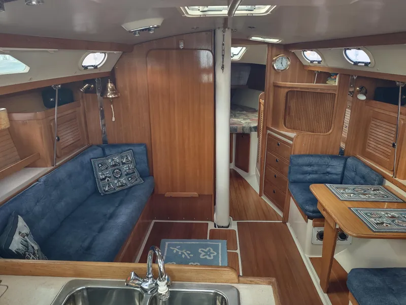 Slide: The Image of Interior of a 2002 Catalina 36 MkII sailboat with blue seating and wooden finishes. - 27