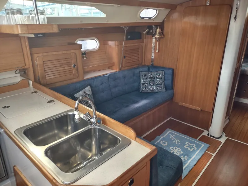 Slide: The Image of Interior of 2002 Catalina 36 MkII sailboat with cozy seating and kitchen area. - 29