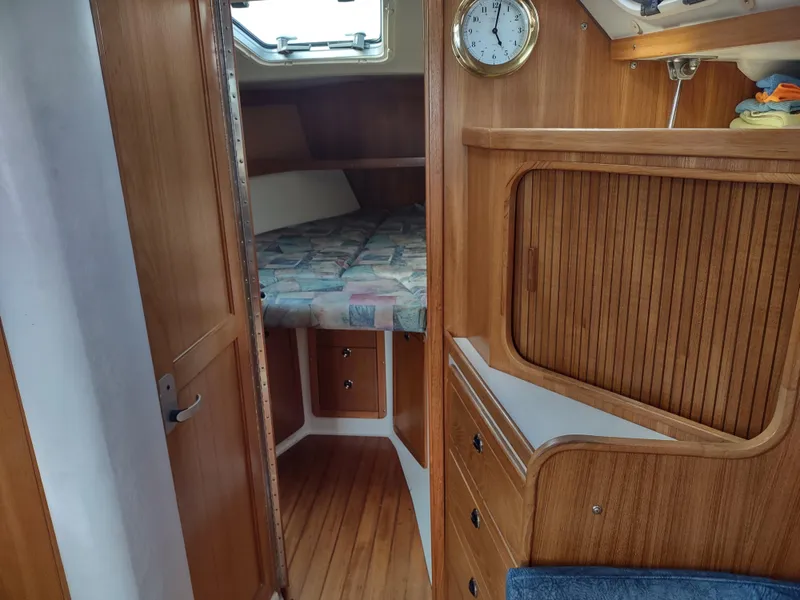Slide: The Image of Interior of a 2002 Catalina 36 MkII sailboat, featuring a cozy cabin with wooden finishes. - 32