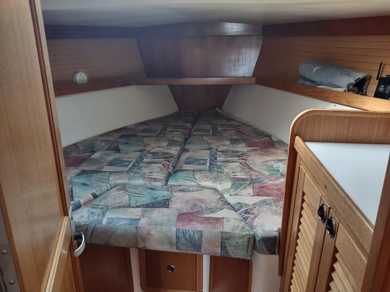 Slide: The Image of Cozy cabin interior of 2002 Catalina 36 MkII sailboat with patterned bedding. - 33