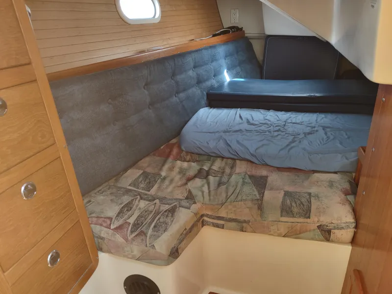 Slide: The Image of Cozy cabin interior of 2002 Catalina 36 MkII sailboat with cushioned seating and wooden cabinetry. - 36