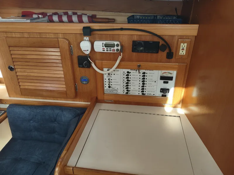 Slide: The Image of Electrical panel and seating area inside a 2002 Catalina 36 MkII sailboat cabin. - 38