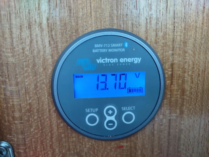 Slide: The Image of Victron Energy battery monitor displaying 13.70 volts on a Catalina 36 MkII, 2002 model. - 41