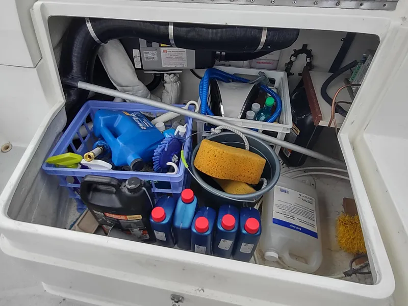 Slide: The Image of Storage compartment of a 2002 Catalina 36 MkII sailboat with cleaning supplies and tools. - 45