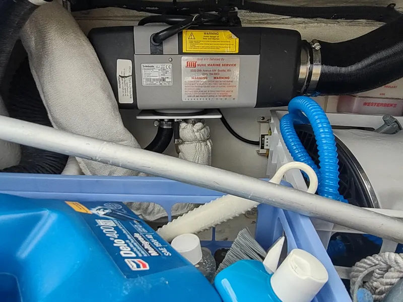 Slide: The Image of Engine compartment of a 2002 Catalina 36 MkII with maintenance supplies and equipment. - 46