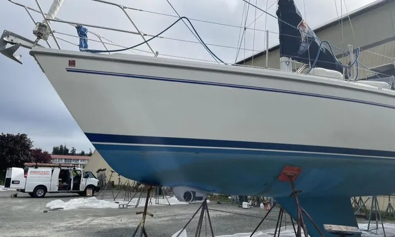 Slide: The Image of 2002 Catalina 36 MkII sailboat on stands, with blue hull and white deck. - 50