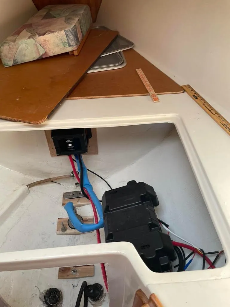 Slide: The Image of Interior view of a 2002 Catalina 36 MkII sailboat showing electrical wiring and storage area. - 51