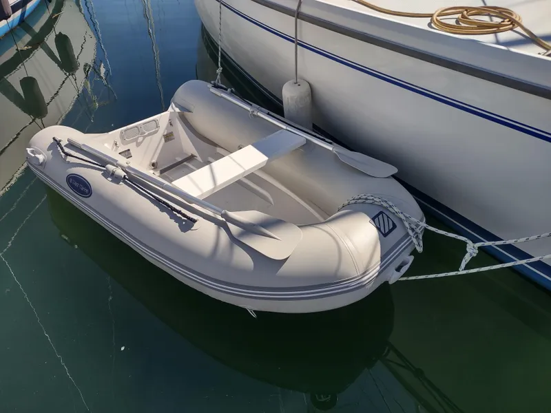 Slide: The Image of Inflatable dinghy moored beside a 2002 Catalina 36 MkII sailboat. - 52