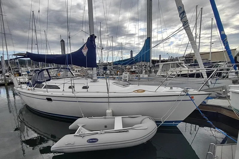 Slide: The Image of 2002 Catalina 36 MkII sailboat docked at marina with inflatable dinghy. - 6