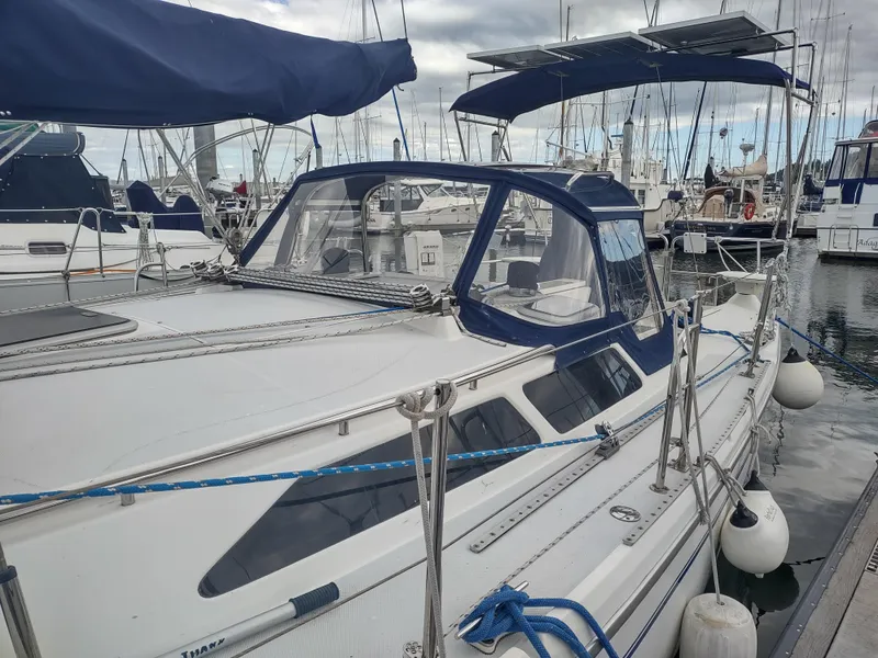 Slide: The Image of 2002 Catalina 36 MkII sailboat docked at marina with blue canopy and fenders. - 7