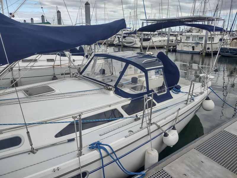 Slide: The Image of 2002 Catalina 36 MkII sailboat docked in marina, featuring blue canvas covers. - 9