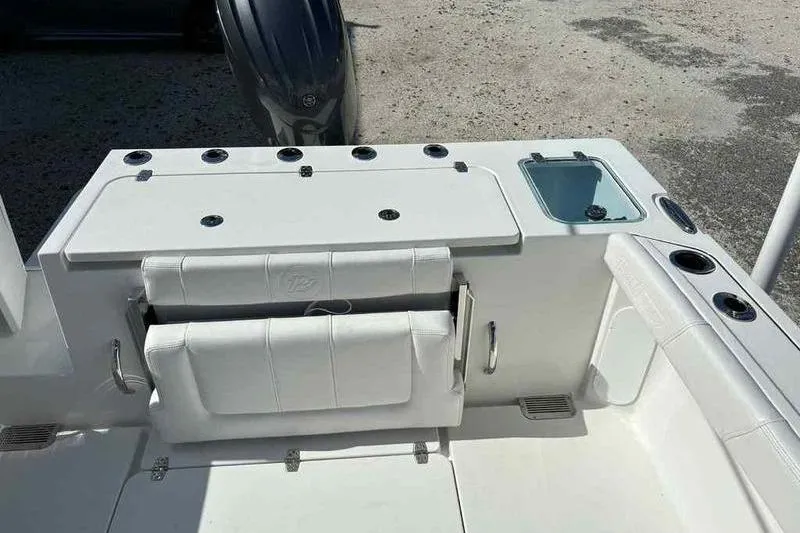 Slide: The Image of 2026 Parker 2220 SC boat interior with white seating and storage compartments. - 11