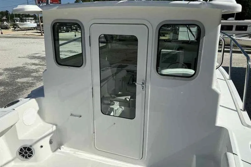 Slide: The Image of 2026 Parker 2220 SC boat cabin with glass door and windows. - 12