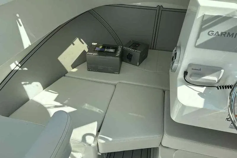 Slide: The Image of 2026 Parker 2220 SC boat interior with Garmin equipment boxes on cushioned seating. - 17
