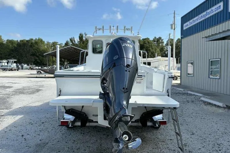 Slide: The Image of 2026 Parker 2220 SC boat with powerful outboard motor, parked at Southern Fishing Boats. - 3