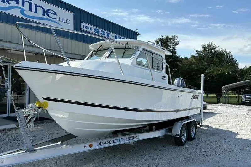 Slide: The Image of 2026 Parker 2220 SC boat on trailer outside marine dealership. - 4