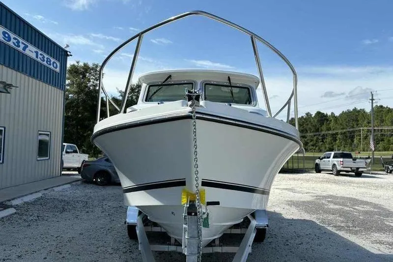 Slide: The Image of 2026 Parker 2220 SC boat on trailer, parked outdoors under clear sky. - 5