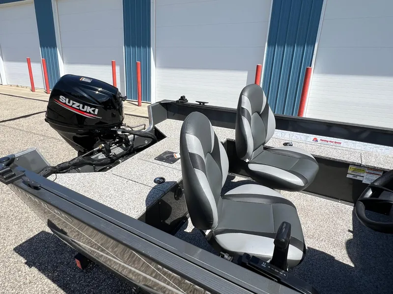 Slide: The Image of 2021 MirroCraft 145 Side Console boat with Suzuki outboard motor, featuring dual seats. - 17