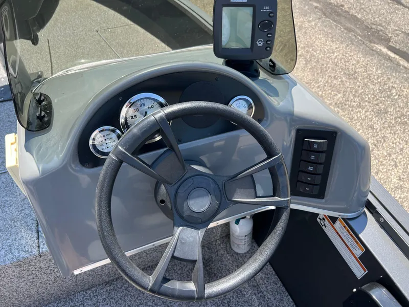 Slide: The Image of 2021 MirroCraft 145 Side Console dashboard with steering wheel and gauges. - 9