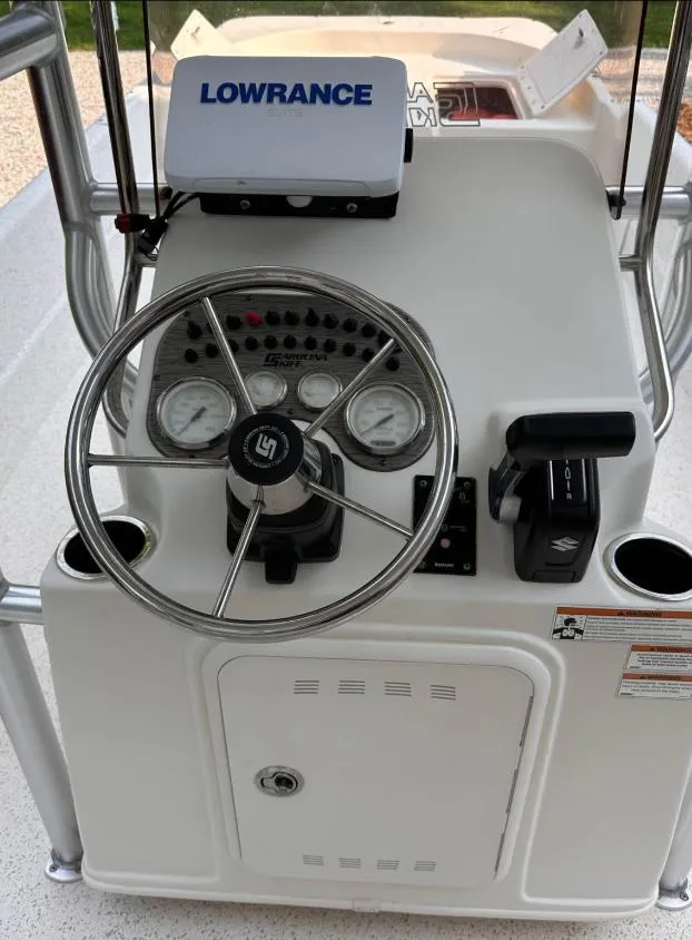Slide: The Image of 2019 Carolina Skiff 24 DLX boat console with steering wheel and Lowrance navigation system. - 9