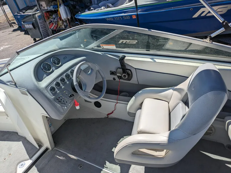 Slide: The Image of Interior of a 1998 Cobalt 200 boat, featuring steering wheel and control panel. - 11