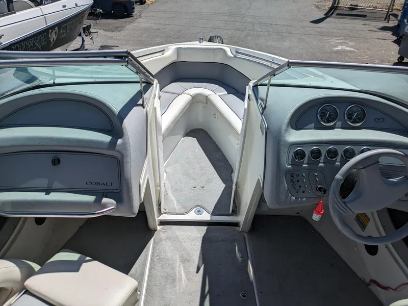 Slide: The Image of Interior of a 1998 Cobalt 200 boat, featuring steering wheel and dashboard controls. - 13