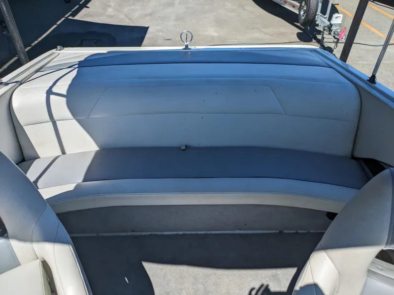 Slide: The Image of 1998 Cobalt 200 boat interior with white cushioned seating and carpeted floor. - 14