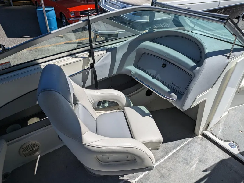 Slide: The Image of Interior of a 1998 Cobalt 200 boat with white seating and dashboard. - 15