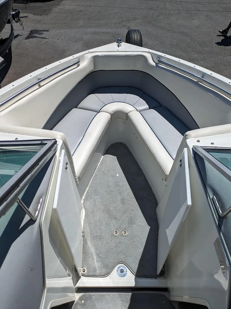 Slide: The Image of 1998 Cobalt 200 boat interior with gray seating and carpeted floor. - 16