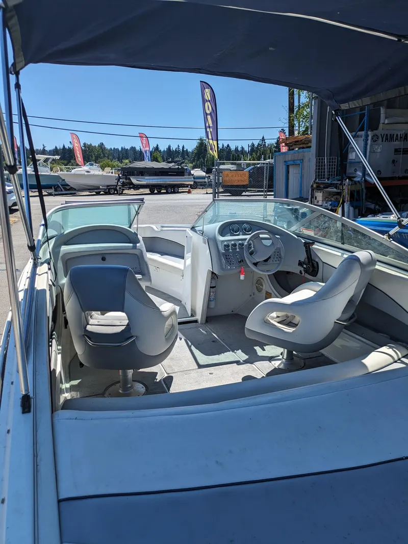 Slide: The Image of Interior view of a 1998 Cobalt 200 boat with seating and steering wheel. - 17