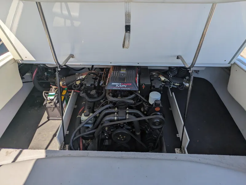 Slide: The Image of Engine compartment of a 1998 Cobalt 200 boat, featuring a 350 MAG MPI engine. - 19