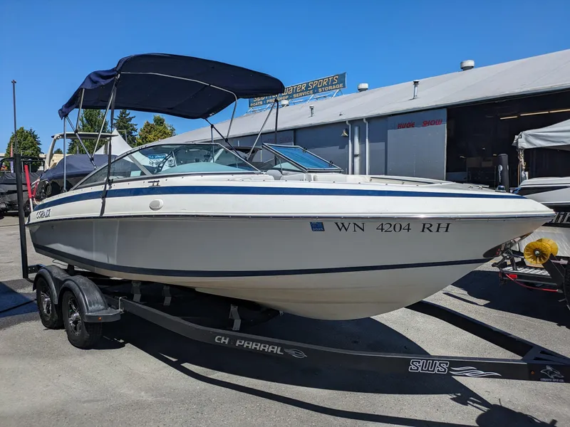 Slide: The Image of 1998 Cobalt 200 boat on trailer, parked outdoors under clear blue sky. - 4