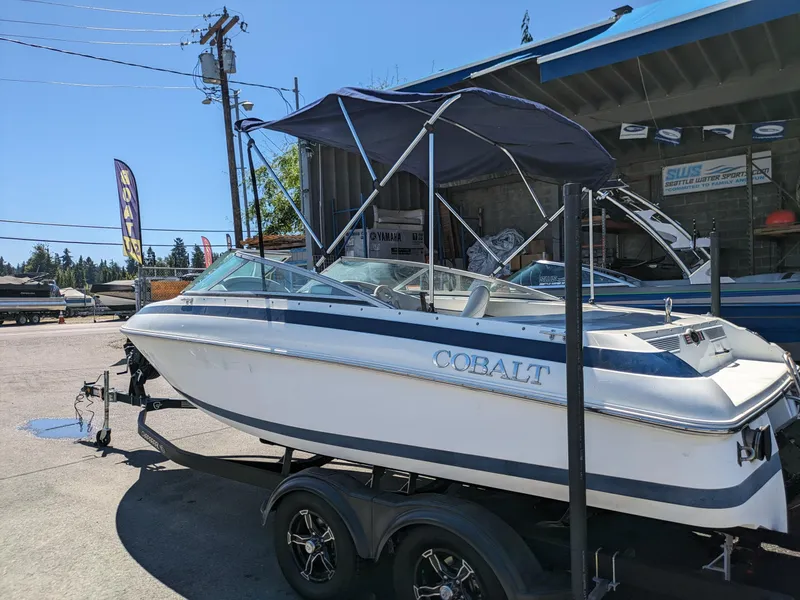 Slide: The Image of 1998 Cobalt 200 boat on trailer, parked outdoors at a dealership. - 5