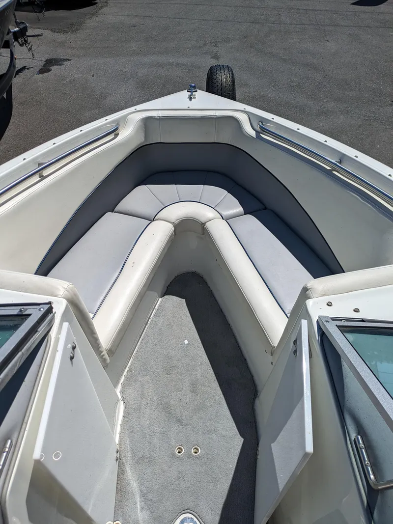 Slide: The Image of Interior of a 1998 Cobalt 200 boat with cushioned seating and carpeted floor. - 9