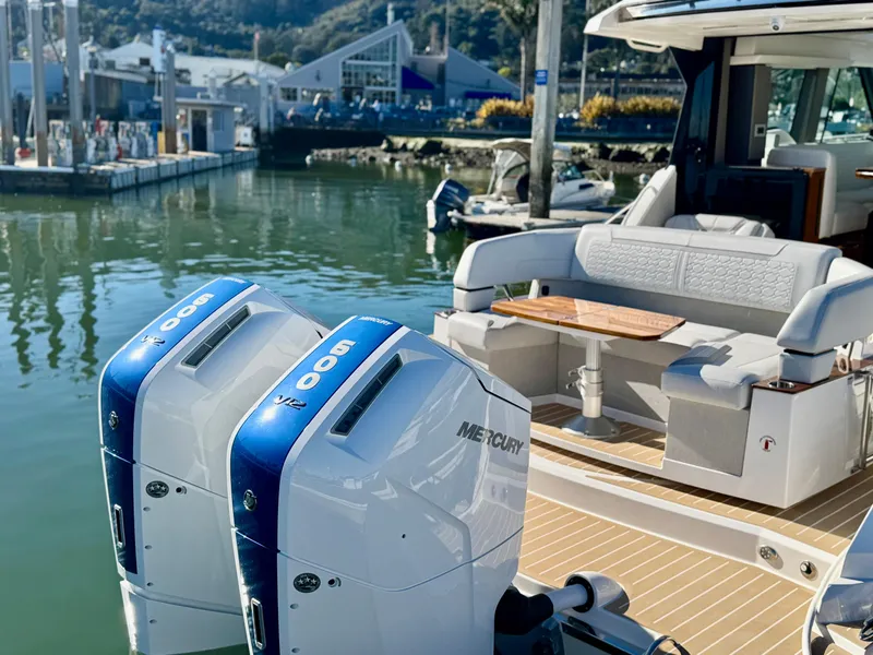 Slide: The Image of 2025 Tiara Yachts 43 LE with dual Mercury outboard engines docked at marina. - 12