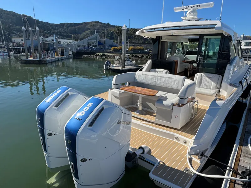 Slide: The Image of 2025 Tiara Yachts 43 LE with dual Mercury 600 engines docked at marina. - 13