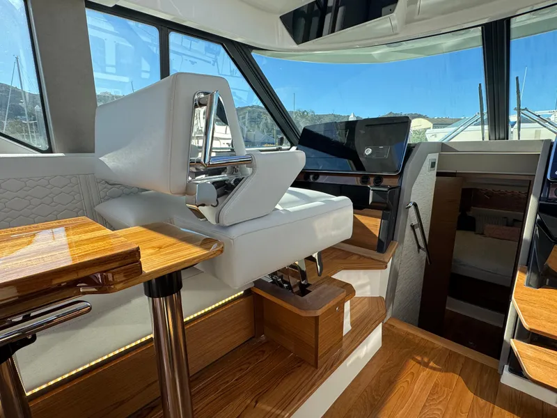 Slide: The Image of Interior of 2025 Tiara Yachts 43 LE, featuring luxurious seating and modern dashboard. - 20