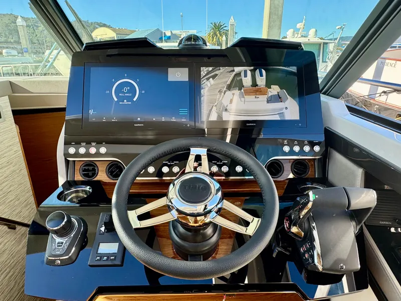 Slide: The Image of 2025 Tiara Yachts 43 LE helm with advanced navigation displays and controls. - 21
