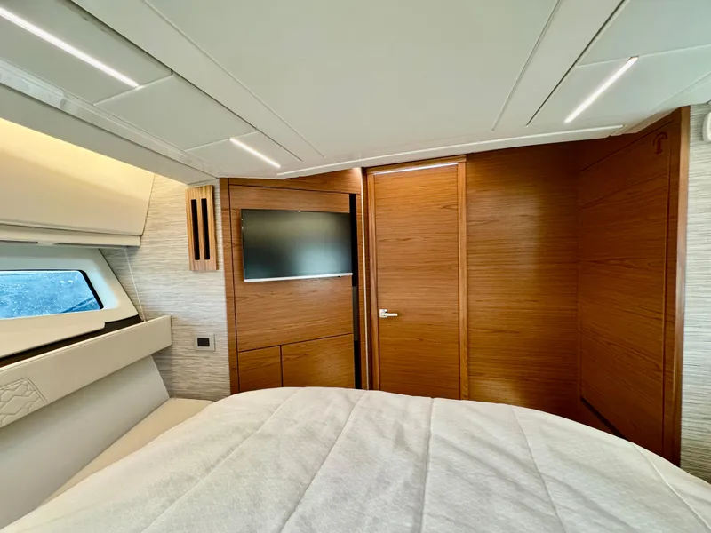 Slide: The Image of Luxurious cabin interior of 2025 Tiara Yachts 43 LE with modern wood finishes. - 29