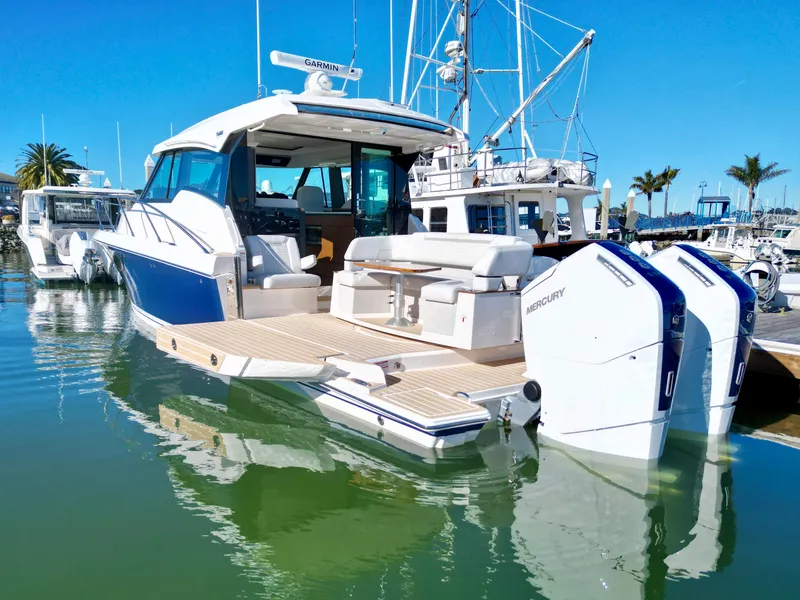 Slide: The Image of 2025 Tiara Yachts 43 LE with Mercury engines docked in a marina. - 3
