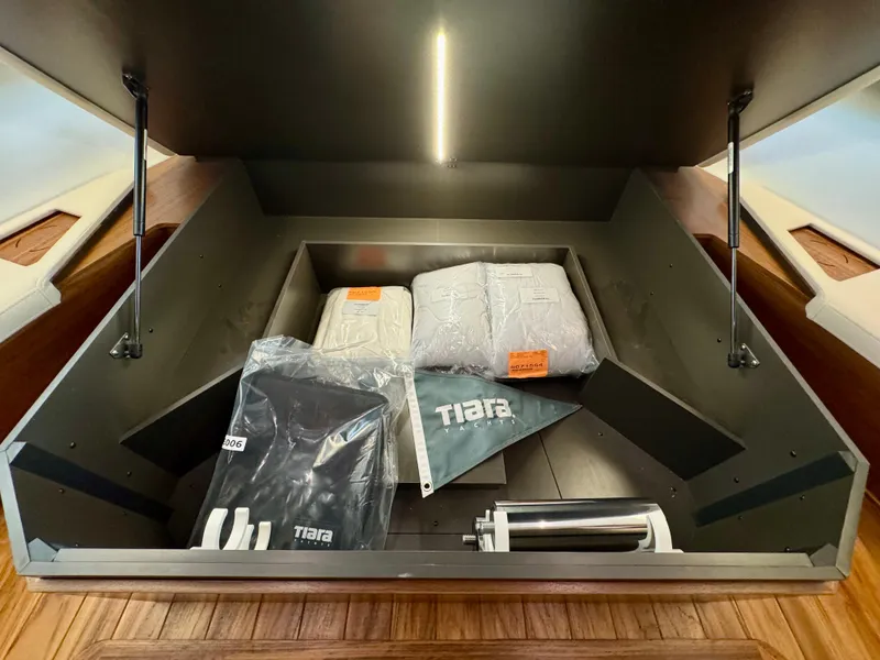 Slide: The Image of Storage compartment in 2025 Tiara Yachts 43 LE, featuring branded accessories and equipment. - 30