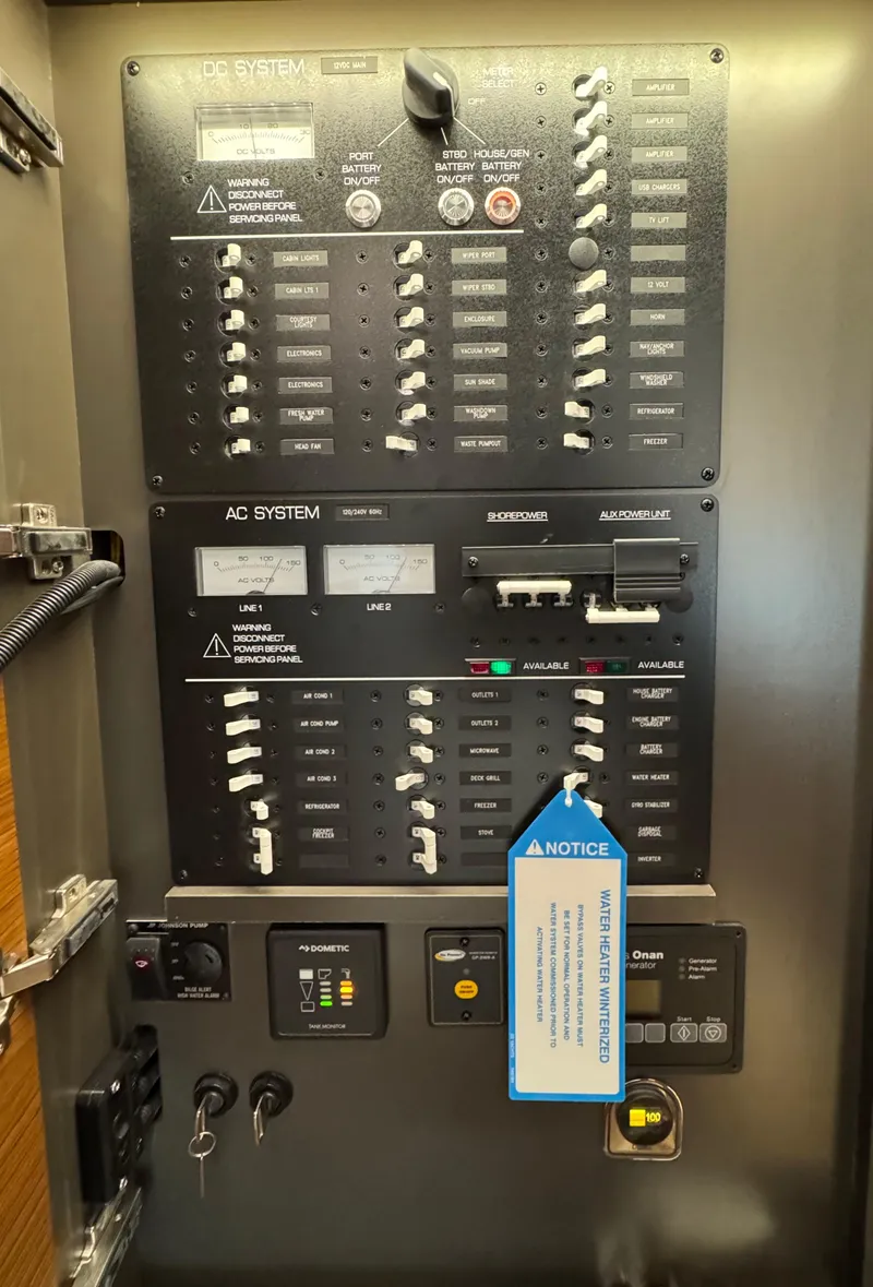 Slide: The Image of Electrical control panel on a 2025 Tiara Yachts 43 LE, featuring AC and DC systems. - 31