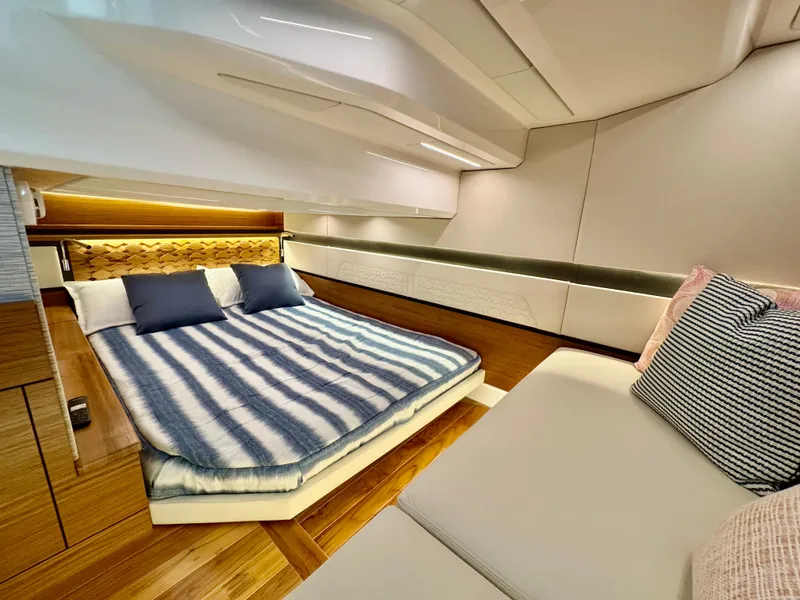Slide: The Image of Luxurious interior of 2025 Tiara Yachts 43 LE, featuring elegant bedding and modern design. - 34