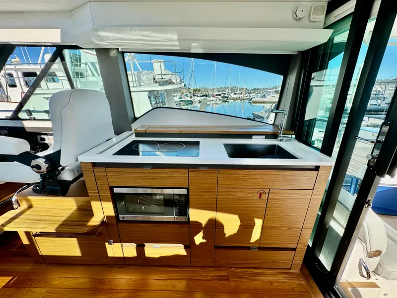 Slide: The Image of Modern kitchen area in 2025 Tiara Yachts 43 LE, featuring sleek design and marina view. - 40