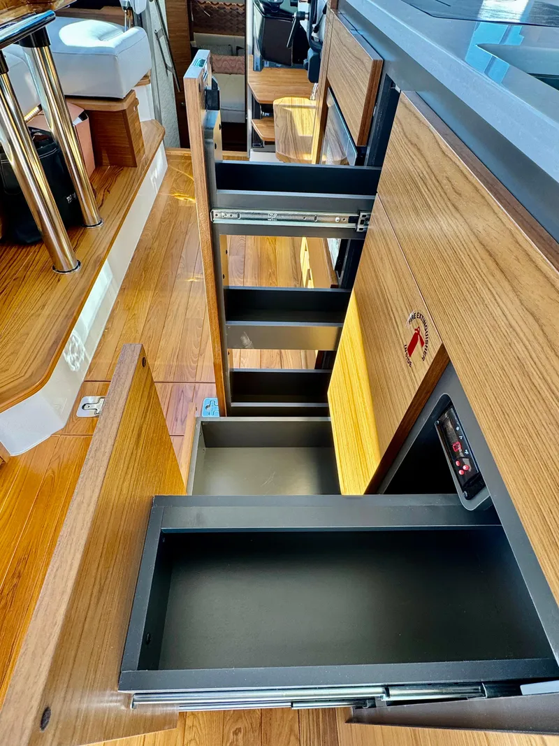 Slide: The Image of 2025 Tiara Yachts 43 LE interior with open wooden storage drawers. - 45