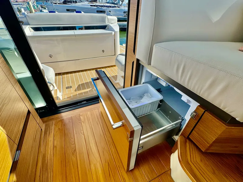 Slide: The Image of Interior of 2025 Tiara Yachts 43 LE with open drawer and seating area. - 46