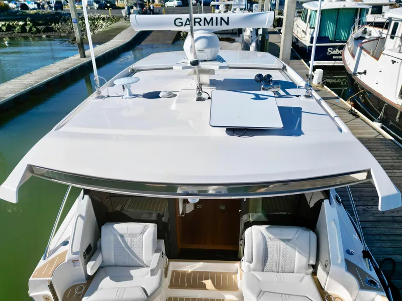 Slide: The Image of 2025 Tiara Yachts 43 LE docked, featuring spacious seating and advanced Garmin navigation. - 5