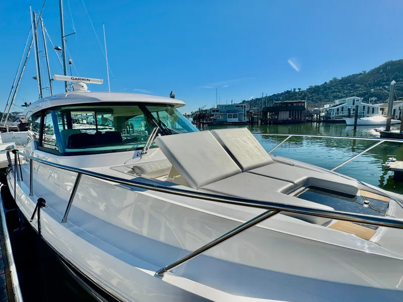 Slide: The Image of 2025 Tiara Yachts 43 LE docked, featuring sleek design and luxurious sunbathing area. - 6