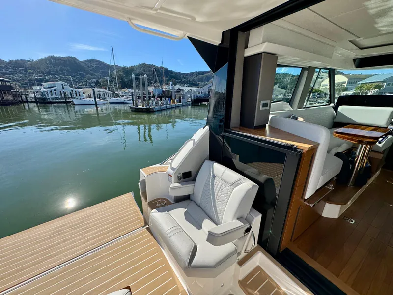 Slide: The Image of 2025 Tiara Yachts 43 LE interior with luxurious seating and scenic marina view. - 9